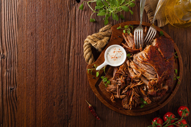 Pulled pork on a wooden board. Top view. - Foto, imagen