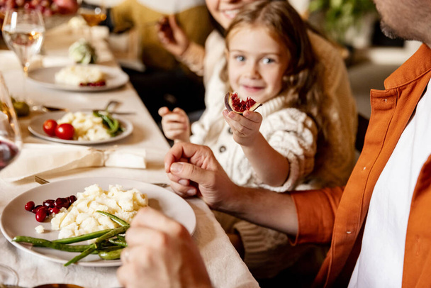Little cute girl, kid with mother and father celebrate Thanksgiving day at home, indoors. Family, holiday concept. - Foto, imagen