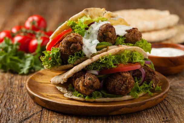 Kebab, kofta in pita, bun. Traditional southern European dish. Front view.  - Zdjęcie, obraz