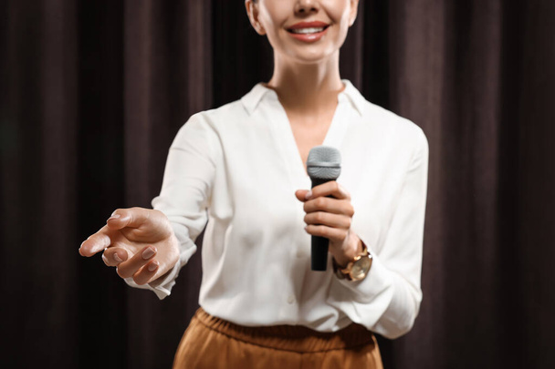 Motivational speaker with microphone performing on stage, closeup  - Photo, Image