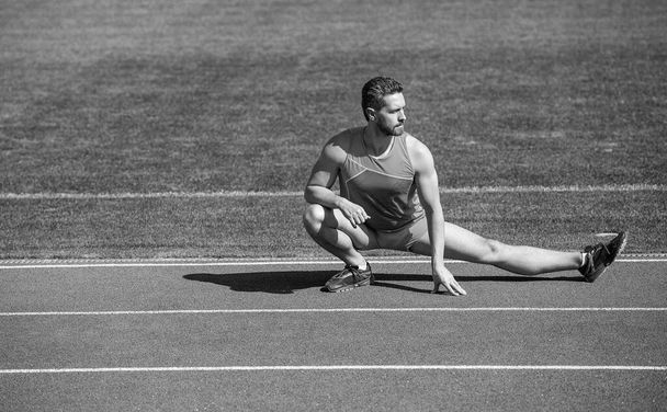 mature man stretching his legs before a stadium workout, stretch - Zdjęcie, obraz