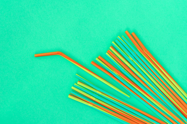 Colorful cocktail straws on blue background. Copy space. - Photo, Image