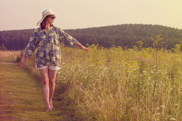 Girl walking on summer field - Fotó, kép