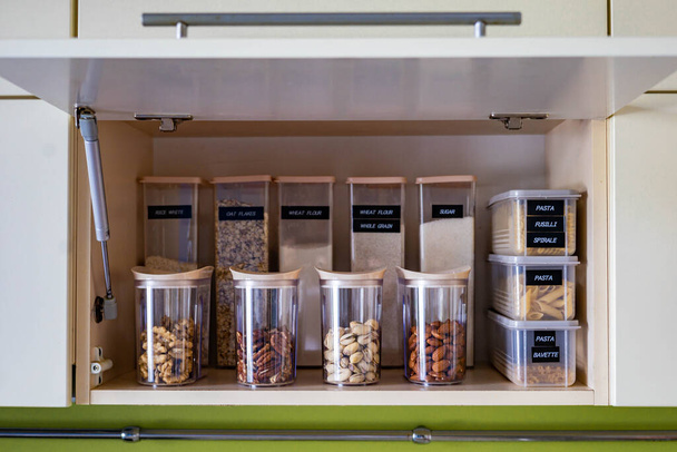 Domestic healthy vegetarian dry food storage organization on shelf at kitchen cupboard - Fotoğraf, Görsel