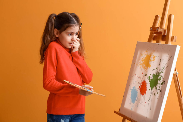 Surprised little painter on color background - Photo, Image