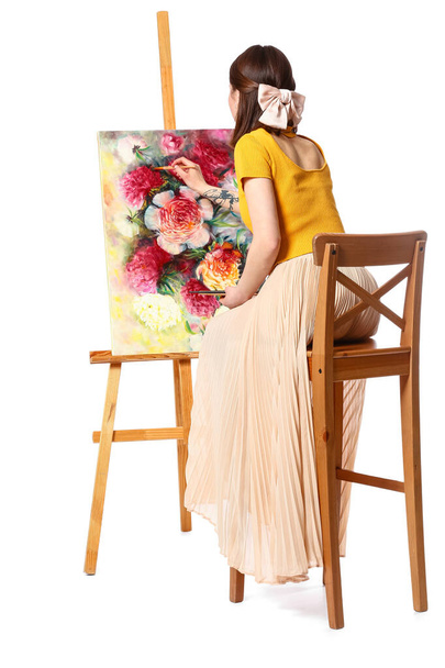 Young female artist painting picture on white background - Photo, Image