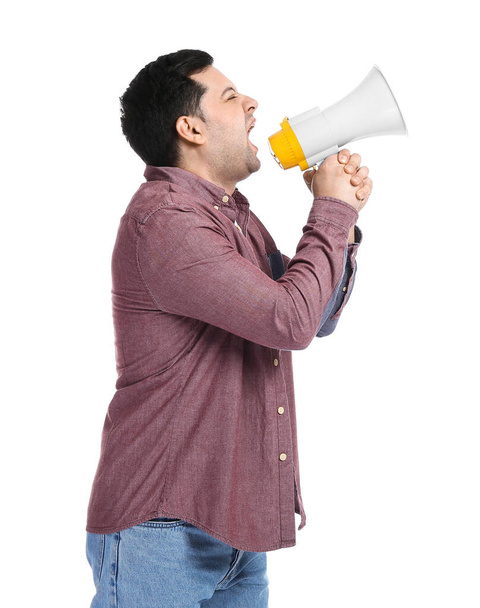 Protesting young man with megaphone on white background - Photo, Image