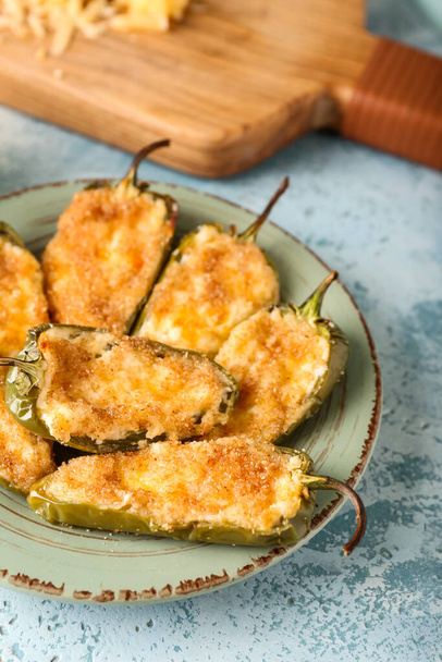 Delicious jalapeno poppers in plate on color background, closeup - Photo, Image