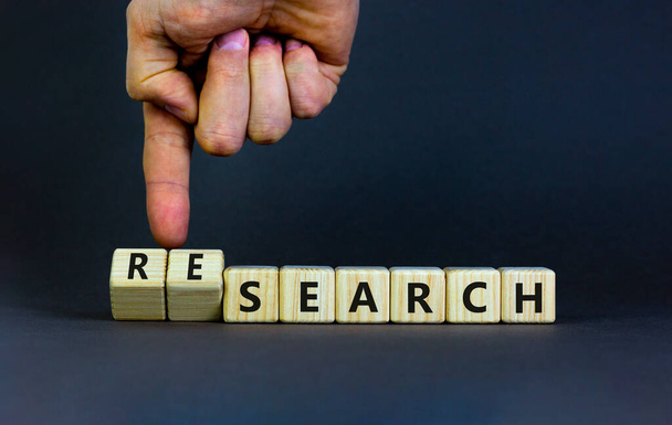 Search or research symbol. Businessman turns wooden cubes and changes the word search to research. Business and search or research concept. Beautiful grey background, copy space. - Foto, Imagen