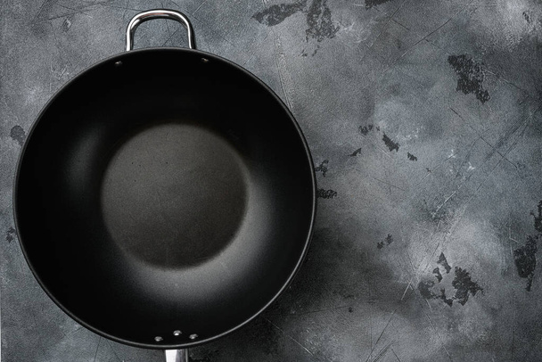 Wok pan empty set with copy space for text or food with copy space for text or food, top view flat lay, on gray stone table background - Photo, Image