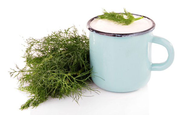 Blue metal mug with cream and dill on white background isolated  - Foto, Imagen