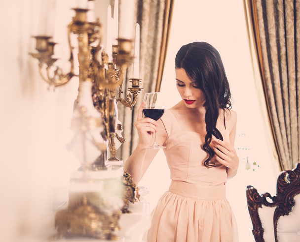 Woman with glass of red wine - Фото, зображення