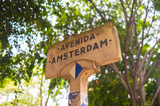 Amsterdam avenue sign with blurry tree as background - Photo, Image
