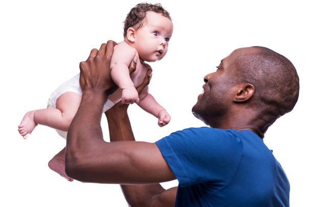 African man holding his little baby - Фото, зображення
