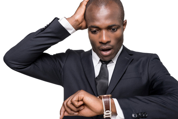 African man in formalwear checking time - Photo, image
