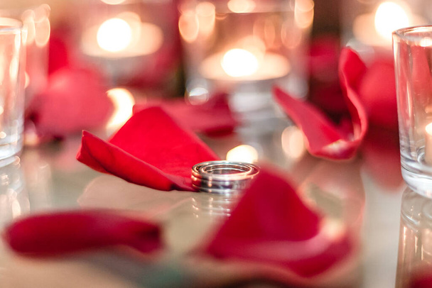 Złota obrączka, obrączka w czerwonym pudełku i czerwone serce na biało-czerwonym tle z pięknym bokeh. Moment ślubu, rocznicy, zaręczyn lub walentynek. Szczęśliwy dzień - Zdjęcie, obraz