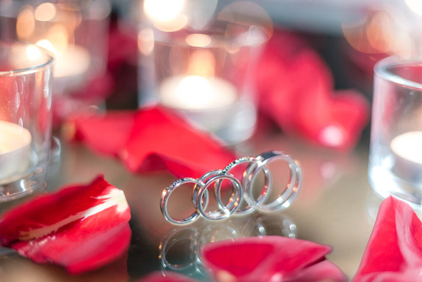 Anillo de oro, anillo de bodas en caja roja y, corazón rojo sobre fondo blanco-rojo con hermoso bokeh. El momento de una boda, aniversario, compromiso o día de San Valentín. Feliz día. - Foto, Imagen