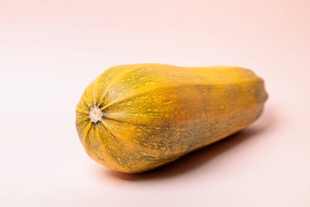 Yellow ripe zucchini on a pink background. Close-up. - Fotoğraf, Görsel