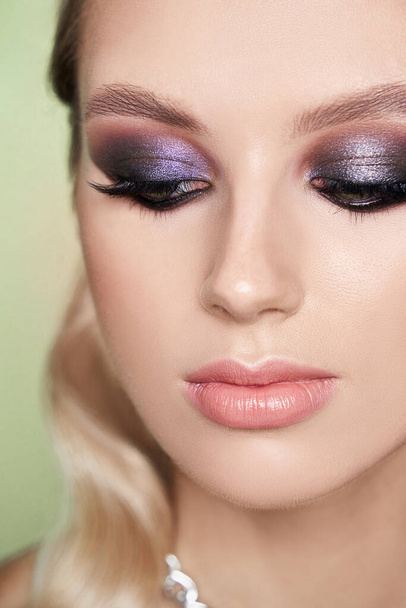 Closeup shot of woman eye with evening makeup. Long eyelashes. Smokey Eyes. Studio shot. - Фото, зображення