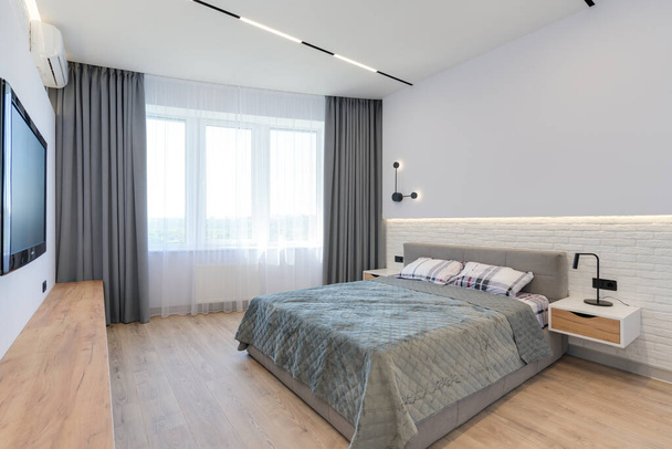 Modern luxus elegáns apartman belső pasztell színekben. Egy nagyon világos szoba, hatalmas ablakokkal, tele napfénnyel. kék falak, fa parketta padló - Fotó, kép
