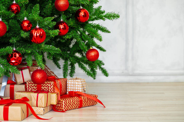 Stack of wrapped presents under Christmas tree - Zdjęcie, obraz