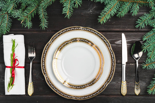 Festive table setting with pine tree branches on wooden background - Fotoğraf, Görsel