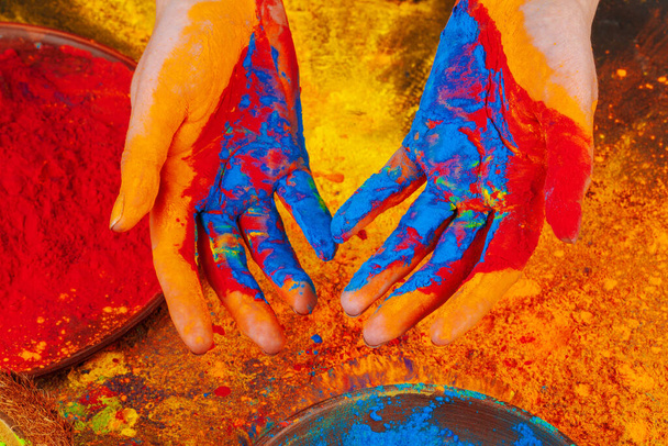 Hands holding Holi powder paint, view from above - Zdjęcie, obraz
