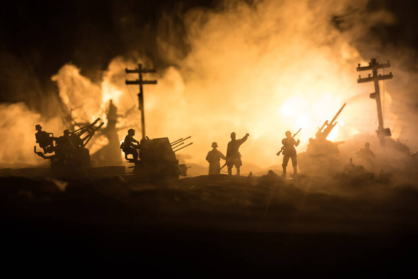 War Concept. Military silhouettes fighting scene on war fog sky background, World War Soldiers Silhouette Below Cloudy Skyline At night. Battle in ruined city. Selective focus - Photo, Image