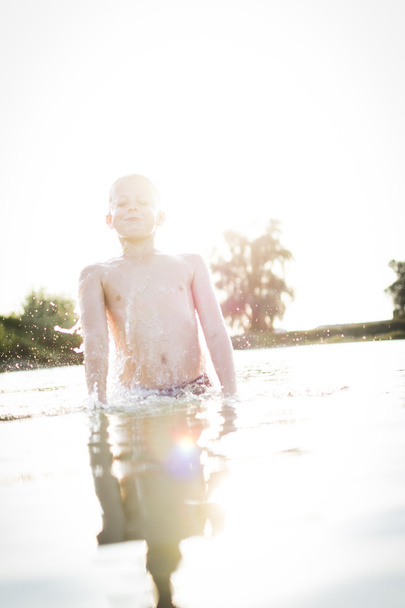 Boy having fun in a lake - Fotoğraf, Görsel