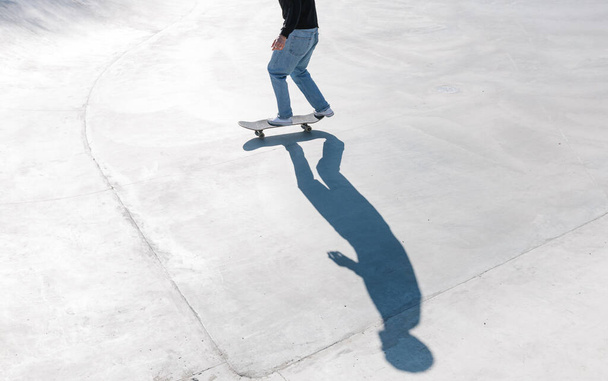 Skateboarding outdoor. Skater skating in an urban concrete skatepark - Fotó, kép