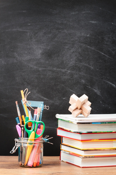 School accessories on desktop with blank blackboard in the backg - Φωτογραφία, εικόνα