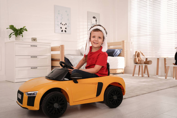 Little child playing with toy car in room - Φωτογραφία, εικόνα