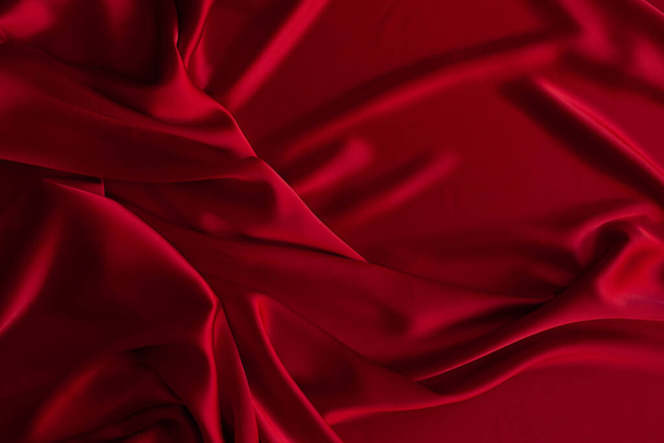 Red fabric texture background. Silk satin folds. Smooth elegant wallpaper - Photo, Image