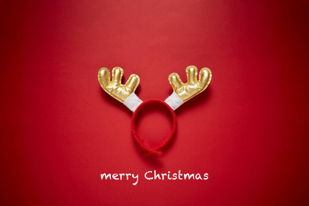 Funny Santa reindeer headband horns isolated on a red background. Top view with copy space.Holiday background - 写真・画像
