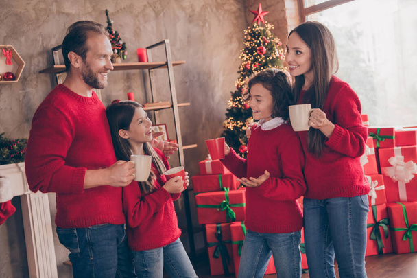 Photo of cheerful relaxed comfort family hold cup enjoy coffee evergreen tree in decorated x-mas home indoors - Photo, image