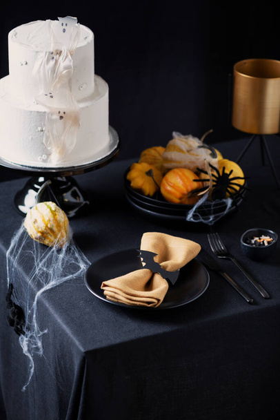 White frosting cake with Halloween decoration on the black table, selective focus image - Fotografie, Obrázek