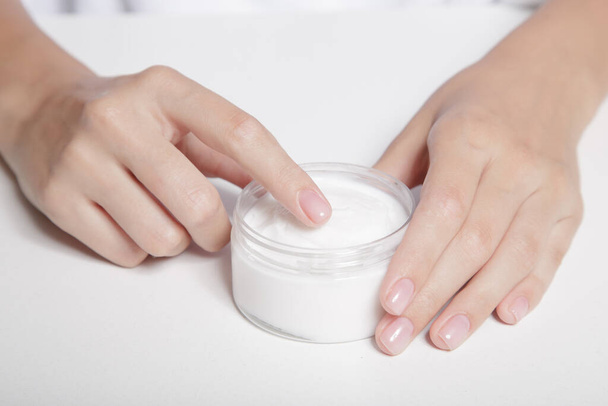 woman hands with perfect manicure open jar of cream - Photo, Image