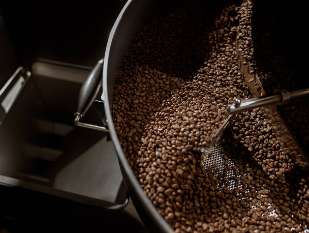 Coffee beans in cooling tray of coffee roasting machine - Fotoğraf, Görsel