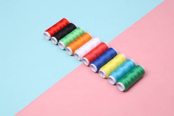 Skeins of colored thread on a blue-pink pastel background - Photo, Image