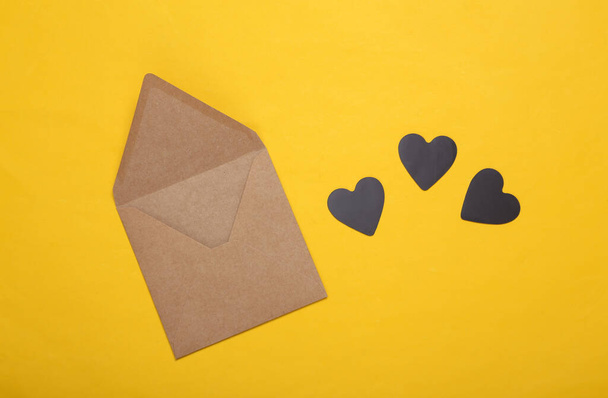 Envelope with hearts on a yellow background. Love concept - Photo, Image