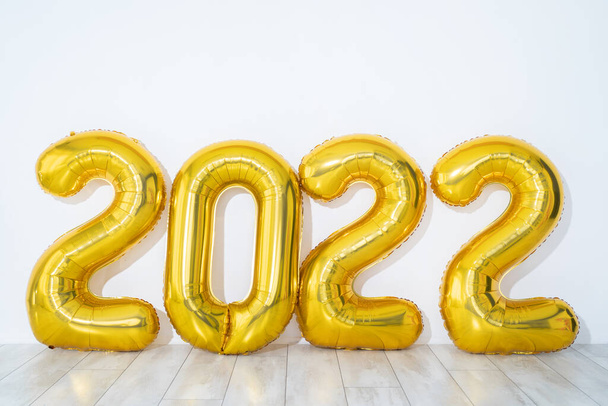 New year concept. Gold Party balloons 2022 numbers shape on white background, panorama, free space - Fotografie, Obrázek