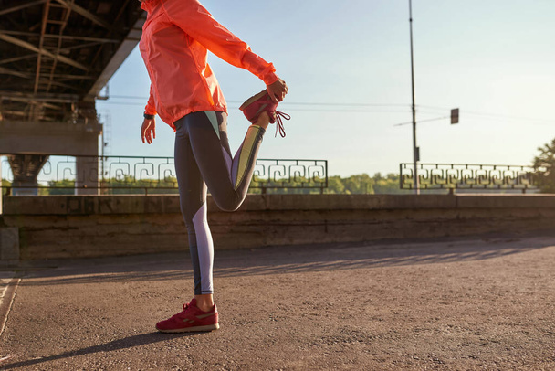 Crop of sporty woman stretch before outdoor training - Fotografie, Obrázek