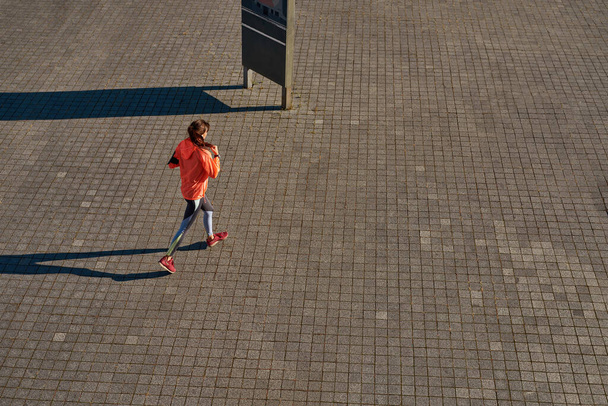 Top view of girl runner train outdoors - Foto, imagen