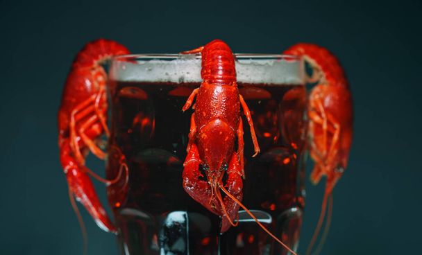 Boiled crawfish crawfish hanging on beer glass. - Photo, Image