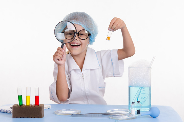 Chemist with the powder and a magnifying glass - Photo, Image