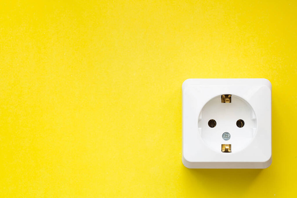 white socket isolated on yellow background - Photo, image