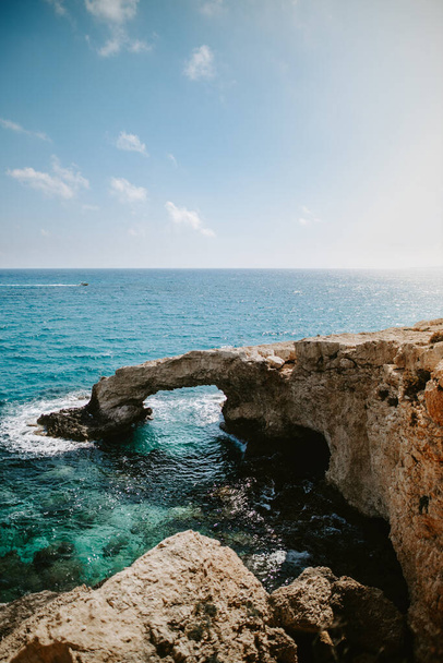 A vertical shot of rocky beach with the Love Bridge in Ayia Napa in Cyprus - Foto, Imagen