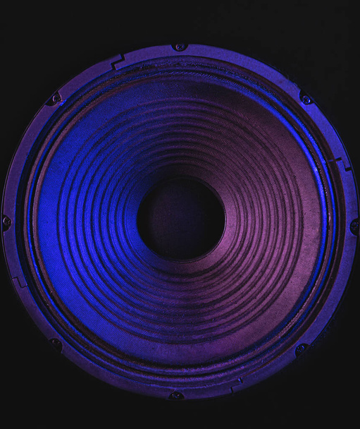 Primo piano della membrana dell'altoparlante su sfondo nero con illuminazione colorata. - Foto, immagini