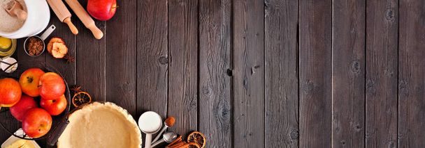 Autumn baking corner border with apple pie ingredients. Top view over a dark wood banner background with copy space. - Φωτογραφία, εικόνα