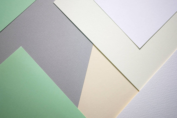 Abstract background from sheets of white, gray and green paper.  background with geometric shapes. Thick paper of different colors top view. Abstract paper - colorful background, creative design  - 写真・画像